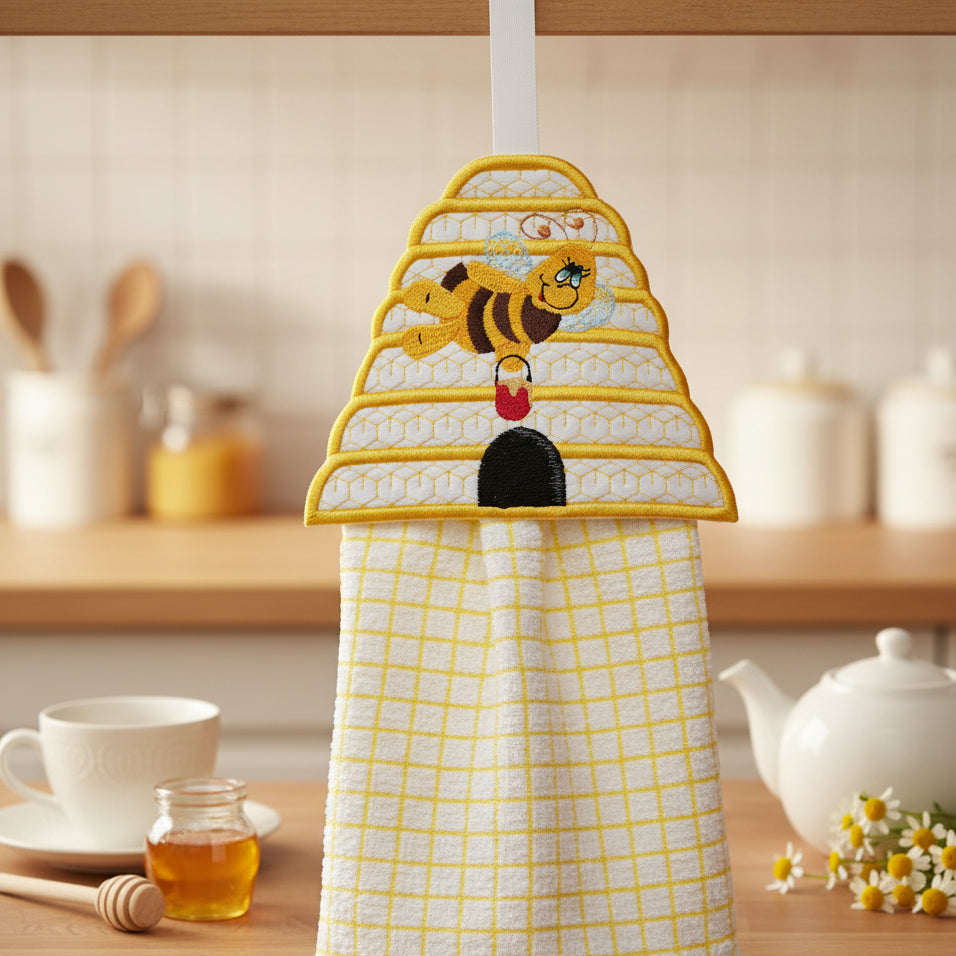 Kitchen towel with bee design hanging on a hook in a kitchen setting