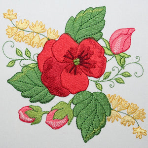 Embroidered design of a red flower with green leaves and yellow buds on a white background