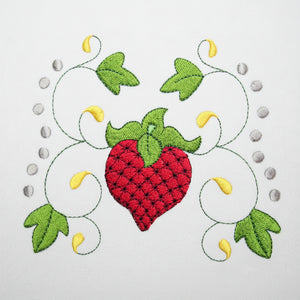 Embroidered design of a red heart with green leaves on a white background