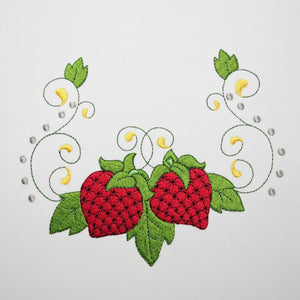Embroidered design of two red strawberries with green leaves on a white background