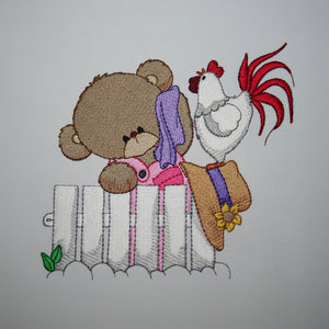 Embroidery design of a teddy bear and rooster on a fence with a gray background