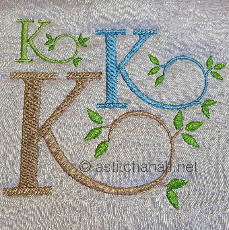 Four different embroidered letters 'K' on a textured fabric background with green leaves.