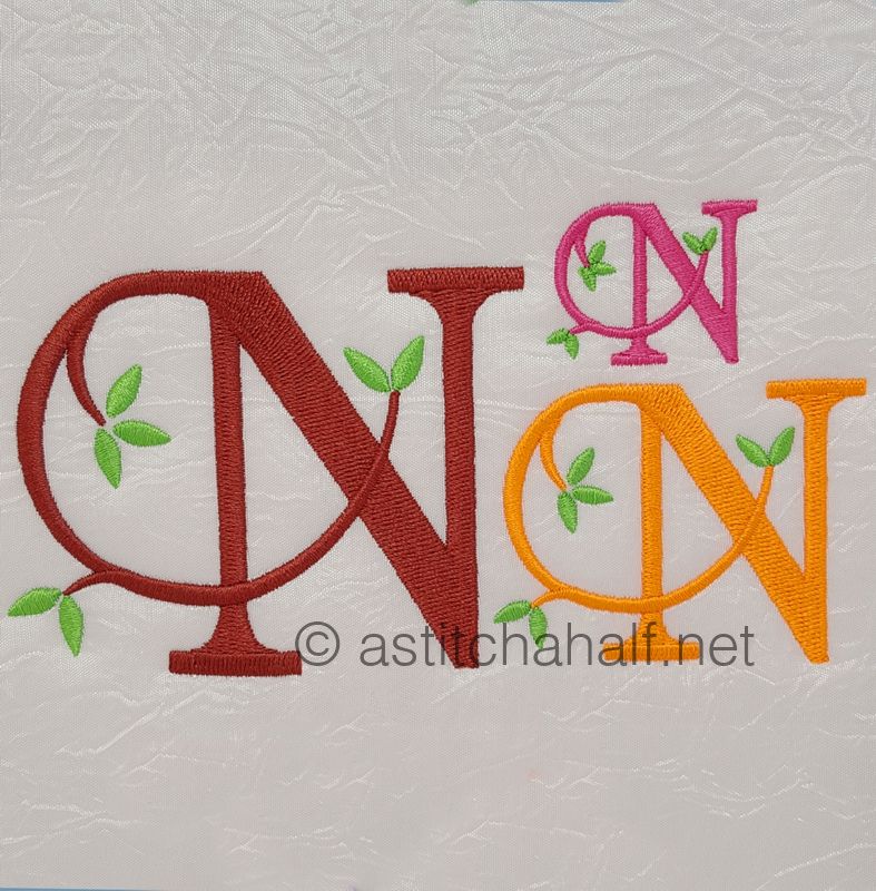 Embroidered letters 'WN' with additional designs on a textured white background