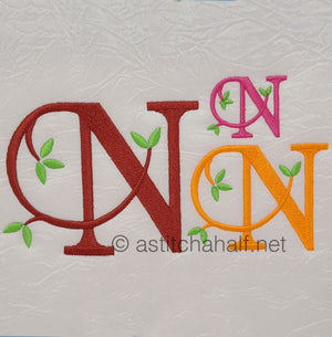 Embroidered letters 'WN' with additional designs on a textured white background