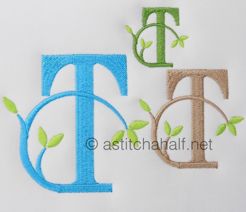 Three embroidered letters 'T' in different colors with green leaves on a white background, featuring the website 'astitchahalf.net'.