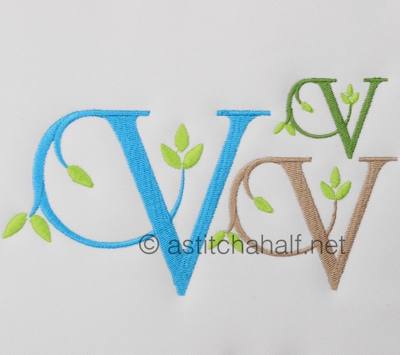 Embroidered monogram with blue, green, and brown letters on a white background.