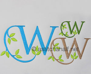 Embroidered letter 'W' with green leaves on a white background, featuring the brand 'a stitch a half'.