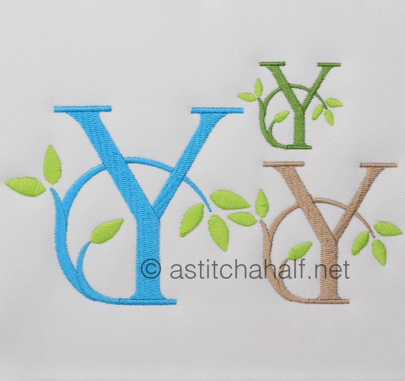 Embroidered letters 'Y' in blue, green, and brown with leaves on a white background.