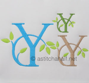Embroidered letters 'Y' in blue, green, and brown with leaves on a white background.