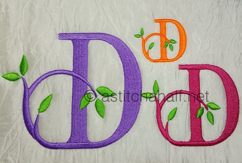 Embroidered letter 'D' with green leaves on a textured background