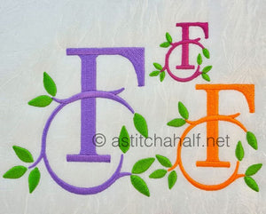 Embroidered monograms with leaves on a white background
