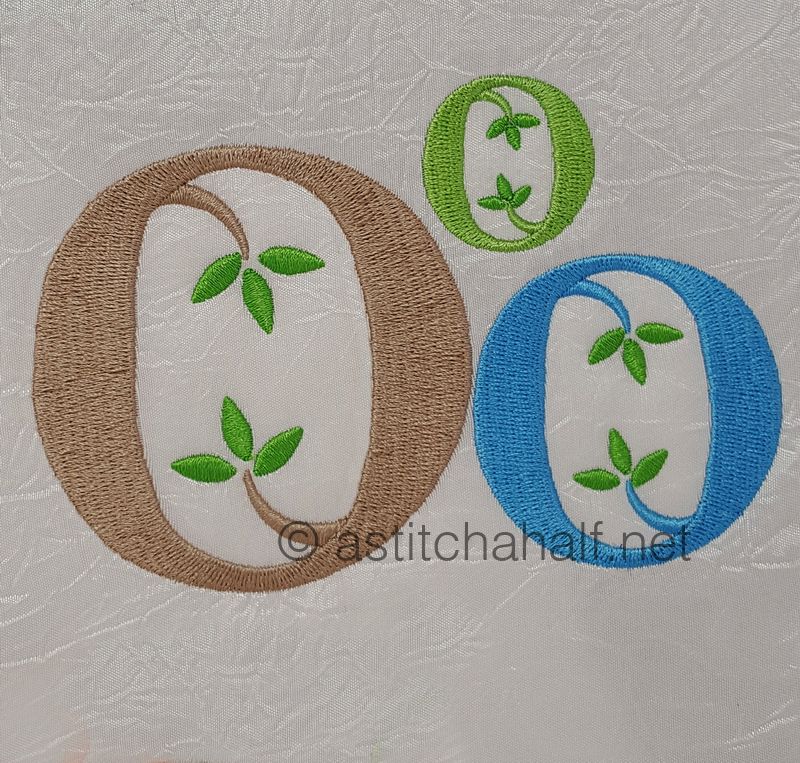 Embroidered letters 'O' in various colors on a textured fabric background.