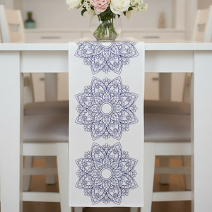 Decorative table runner with mandala patterns on a white table