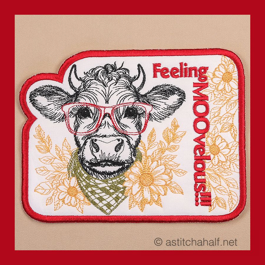 A fabric mug rug with the text 'Feeling Moovelous' and an illustration of a bull wearing glasses and a bandana, surrounded by floral designs.