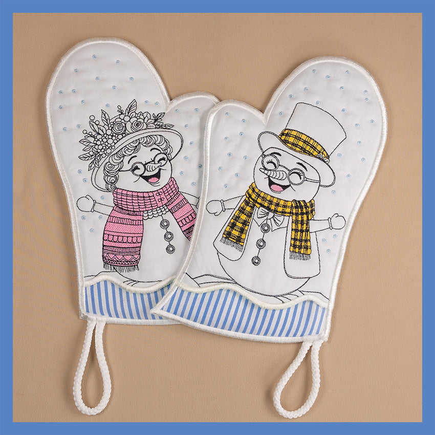 A pair of oven gloves featuring cartoon illustrations of a snowman and a snowwoman on a white background with blue stripes.