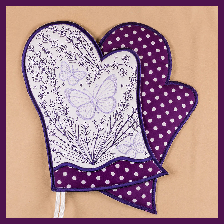A pair of lavender theme oven gloves with floral and butterfly embroidery designs.