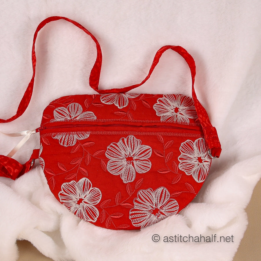 Red bag with white floral pattern on a white background