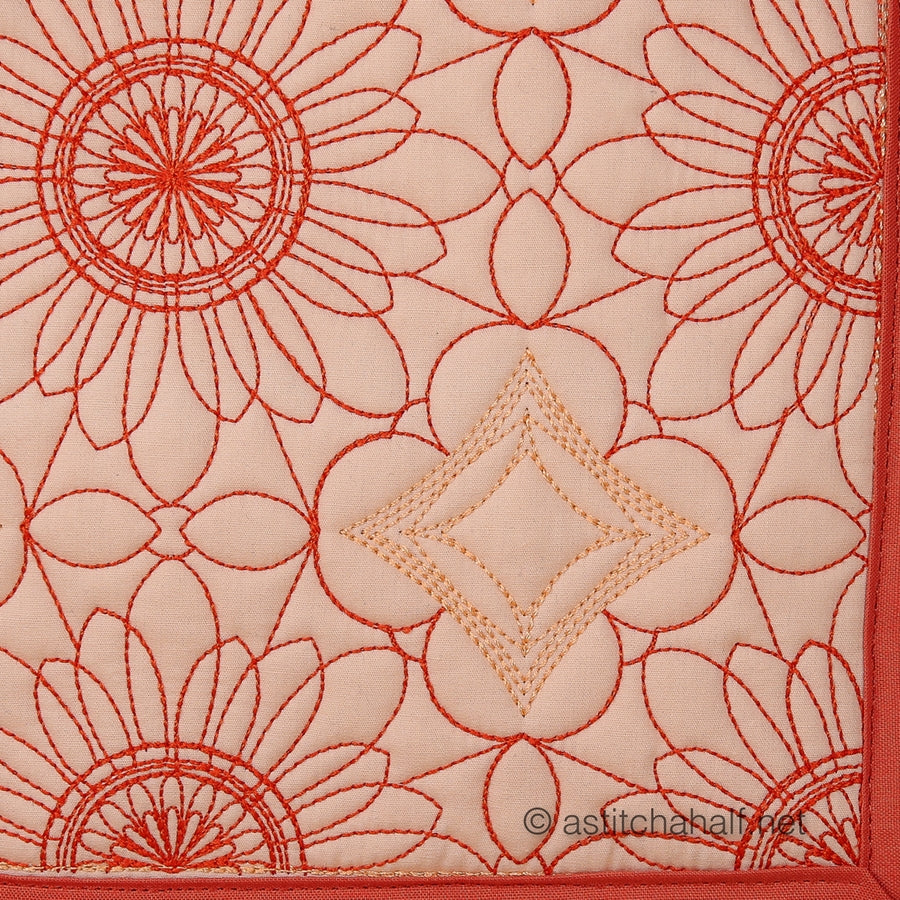 Close-up of red floral embroidery on a beige fabric background