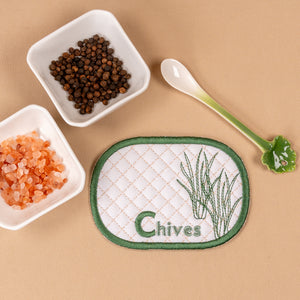 Patch with 'Chives' text and illustrations on a beige background with small containers of spices.