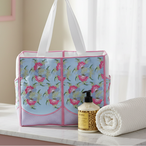 Floral-patterned tote bag with a bottle and towel on a marble surface