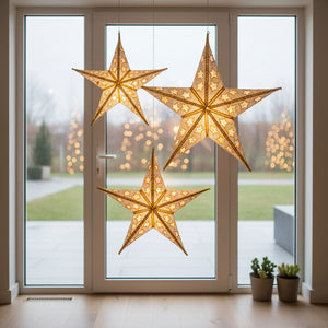Decorative star ornament with gold and white pattern on a textured brown background