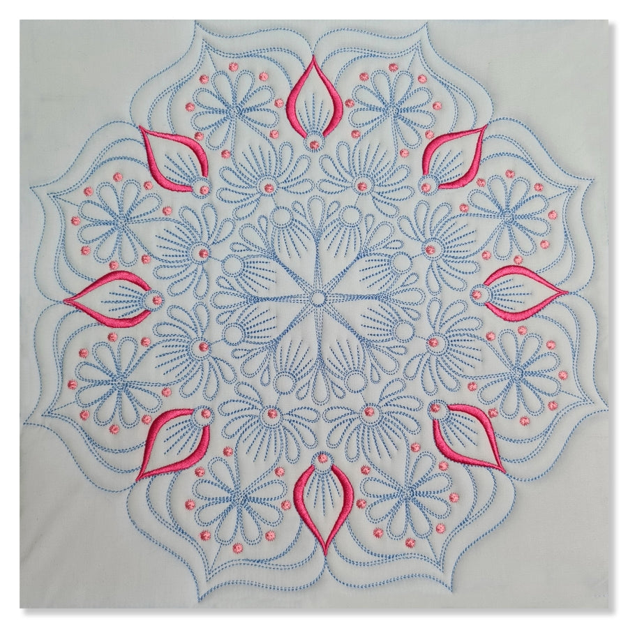 Embroidered design with pink and blue patterns on a light gray background