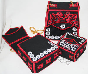 Black embroidered bag with red and white patterns on a white background
