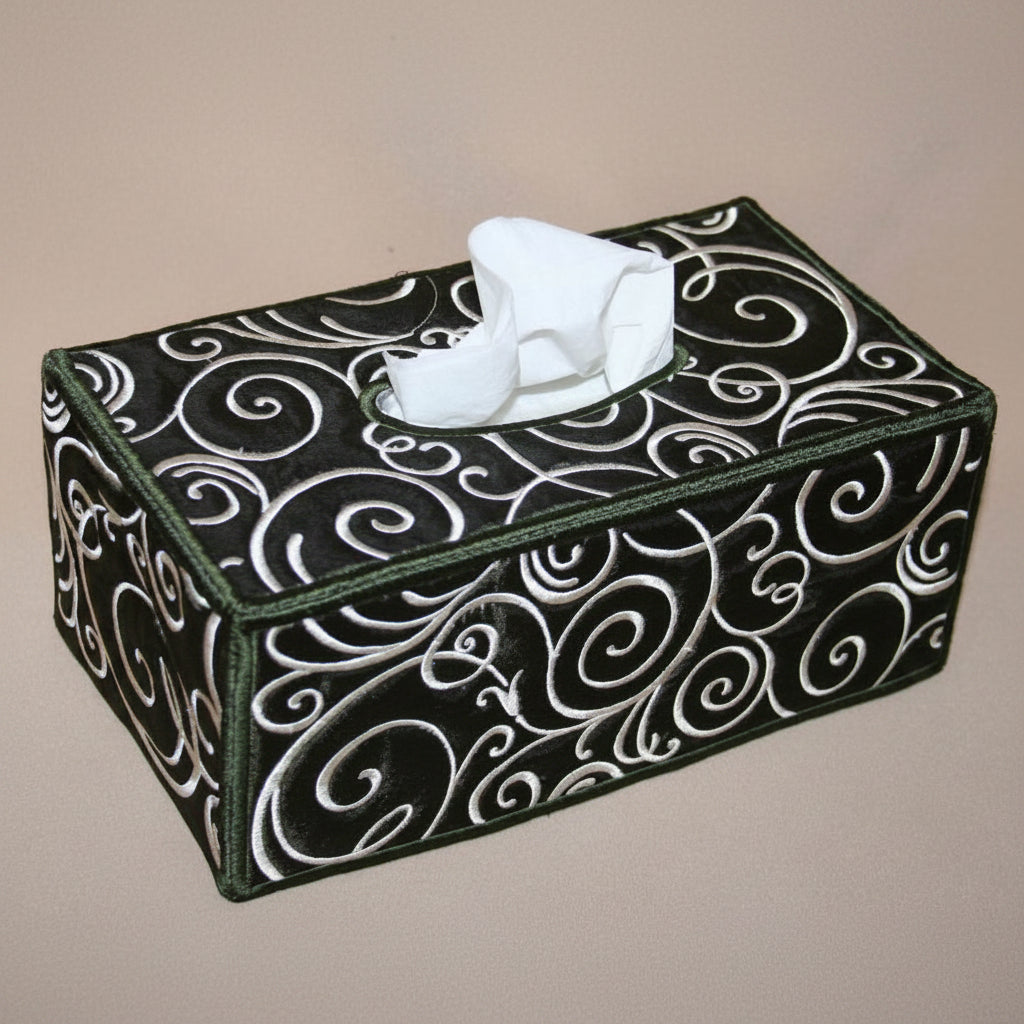 Tissue box on a bathroom counter with towels and soap