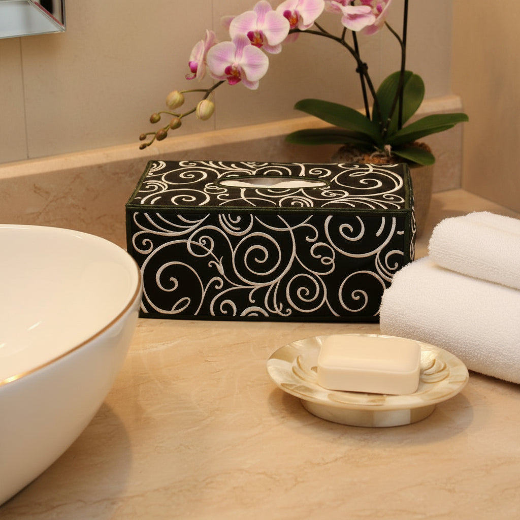 Tissue box on a bathroom counter with towels and soap