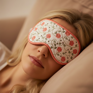 Person wearing a floral eye mask while lying down