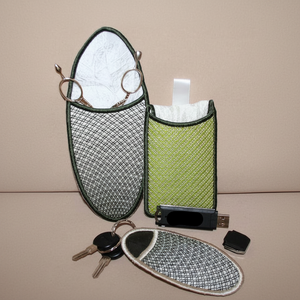 Set of green and gray mesh pouches with a USB device and keys on a beige background