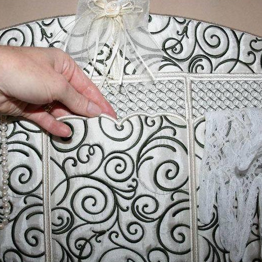 Decorative hanger with black and white pattern on a beige background