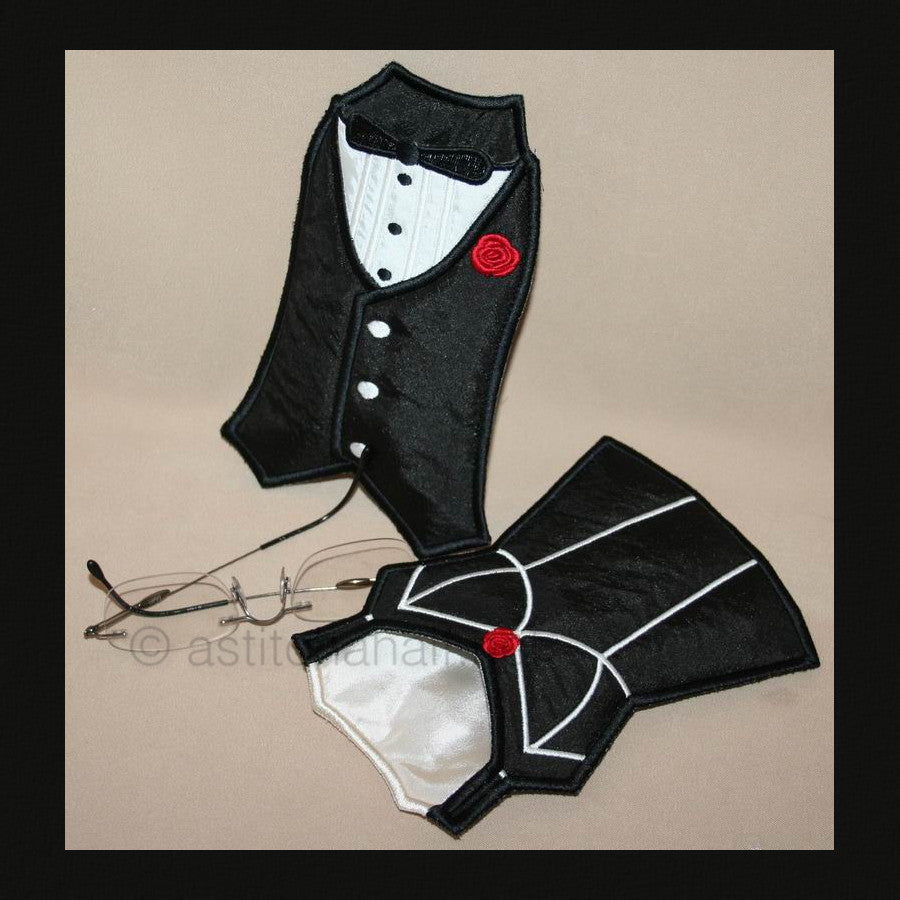 A pair of eyeglass cases designed to look like a man's and woman's shirt, embroidered in black with white outlines and red accents, displayed with sunglasses for scale.